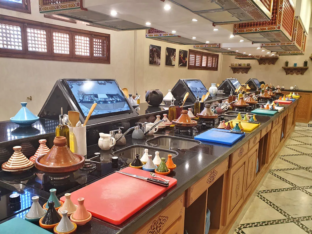 Traditional Moroccan restaurant kitchen with tagines lined up.