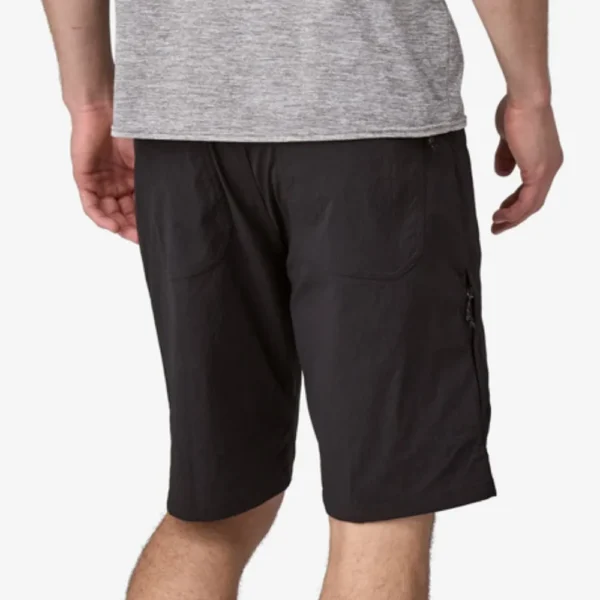 Man wearing gray-black cargo shorts standing